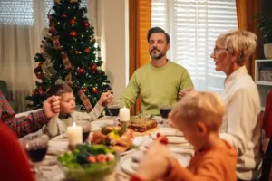 Family around dining table at Christmas